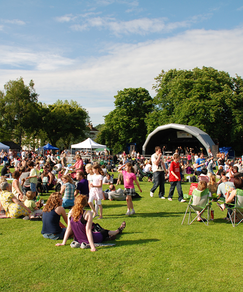 Audience watching the free local music festival in a local park